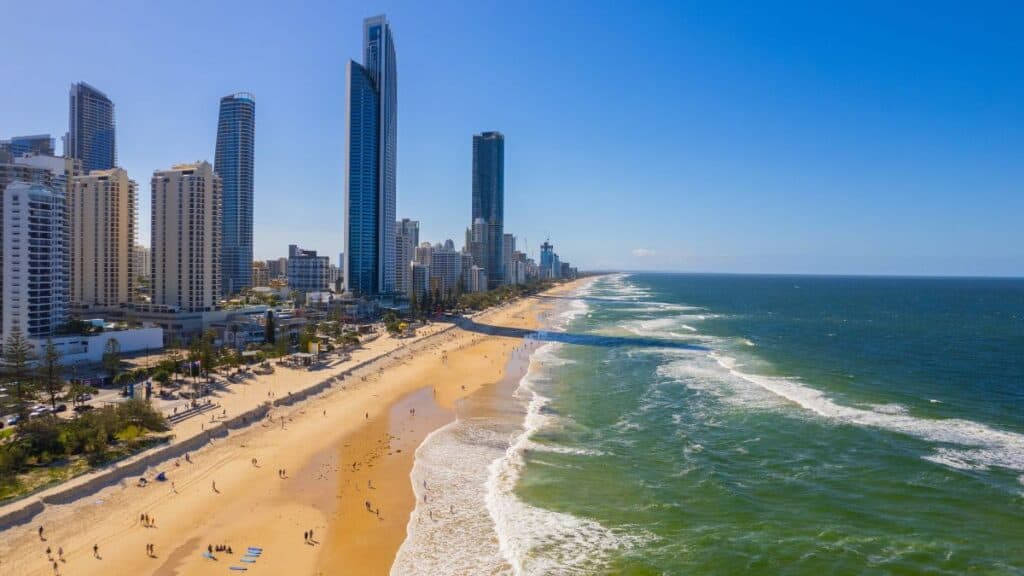 Gold Coast skyline with high-rise buildings and sandy beach in Australia.