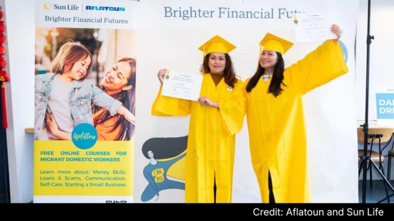 Hong Kong domestic workers in yellow caps celebrate financial literacy programme success.