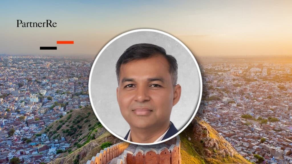 Ankur Gupta, CEO India, appointed by PartnerRe, in front of Mumbai skyline at sunset.