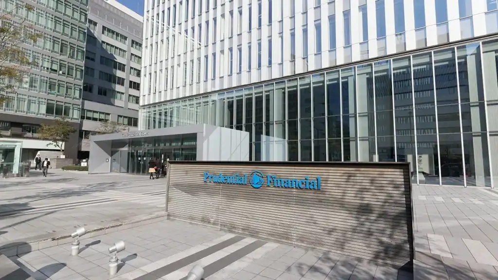 Modern office complex exterior with glass facade and a prominent 'Prudent Financial' sign in blue.