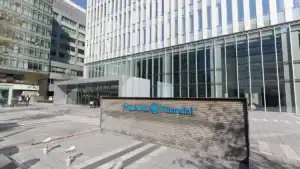 Modern office complex exterior with glass facade and a prominent 'Prudent Financial' sign in blue.