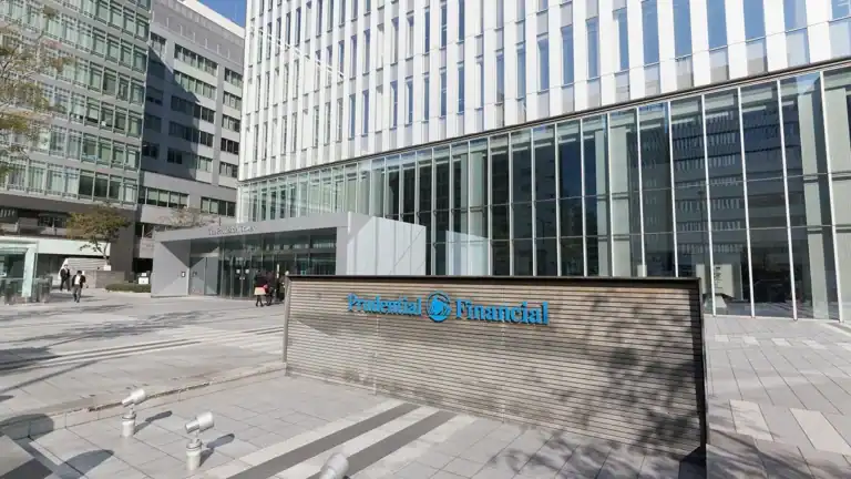Modern office complex exterior with glass facade and a prominent 'Prudent Financial' sign in blue.
