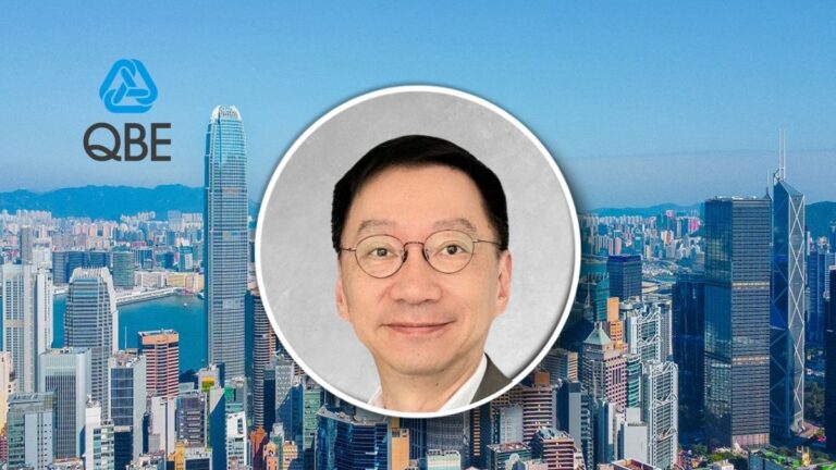 Portrait of a man in glasses in a circular frame over a Hong Kong city skyline with the QBE logo in the sky behind him.