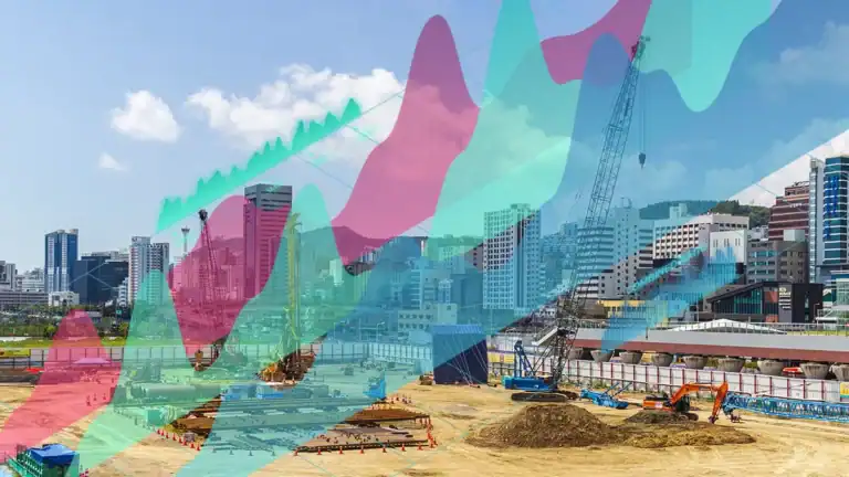 City construction site with cranes and dug earth, overlaid by colorful data graphs.