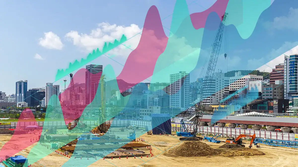 City construction site with cranes and dug earth, overlaid by colorful data graphs.
