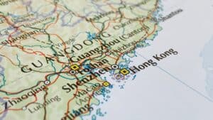 Close-up map of southern China showing Guangzhou, Shenzhen, and Hong Kong with road lines and coastlines.
