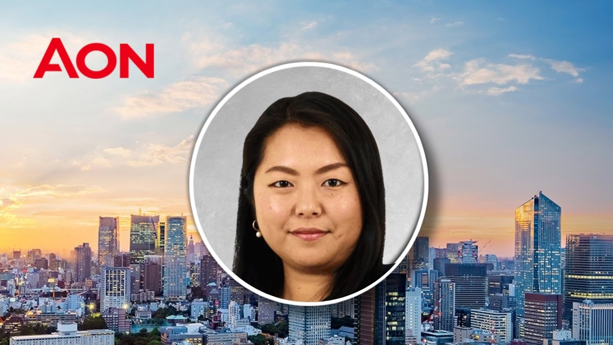 Kayo Montgomery, Asia strategic account manager at Aon, in front of a city skyline at sunset.