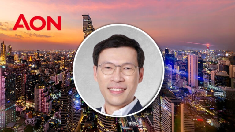 City skyline at sunset with the red AON logo and a circular portrait of a smiling man wearing glasses in the center.