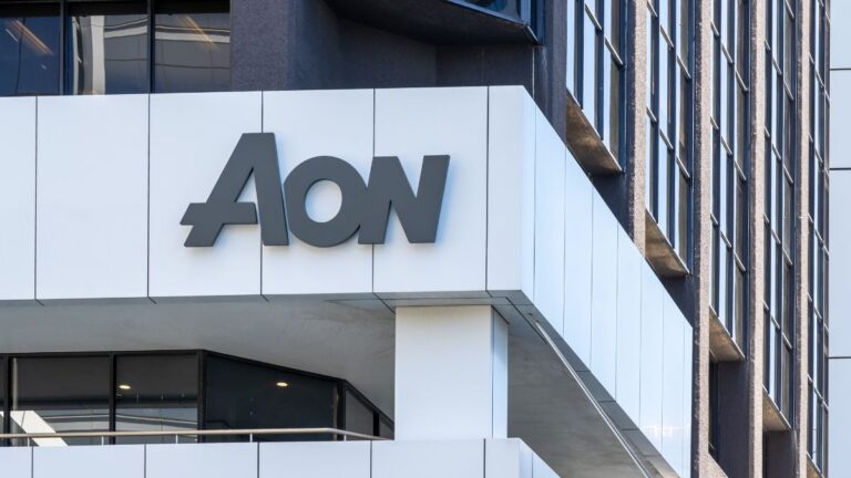AON logo on a white panel of a modern office building exterior, with glass windows nearby