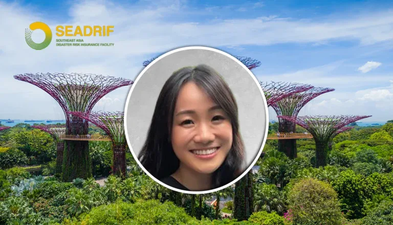 Circular portrait of a smiling woman over a background of Gardens by the Bay Supertree Grove and the SEADRIF logo on the top left.