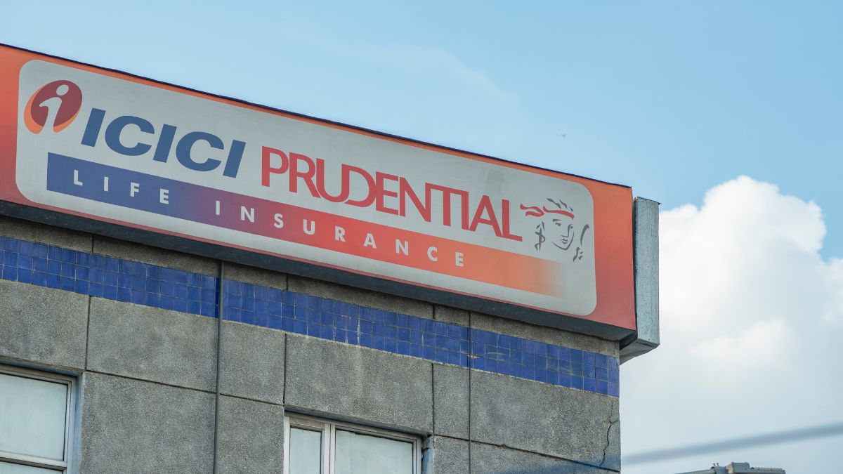 Sign on a building reads 'ICICI PRUDENTIAL LIFE INSURANCE' with a small logo against a blue sky.”,