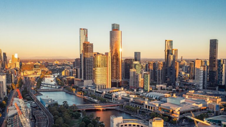 Sydney skyline with skyscrapers and Harbour Bridge at sunset, Australia.