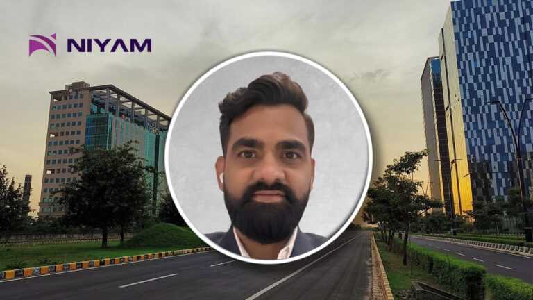 Corporate banner with NIYAM logo and a circular portrait of a man with a beard over a city street background.