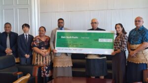 Tonga officials receive a cheque from Bank South Pacific for drought relief funds.