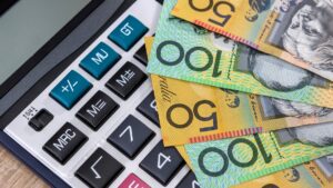 Australian dollar notes and calculator, related to superannuation and financial claims.