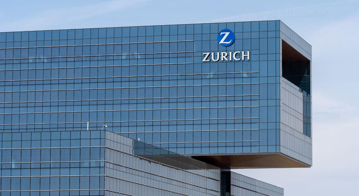 Zurich building in Zurich, Switzerland, with blue glass facade and Zurich logo.