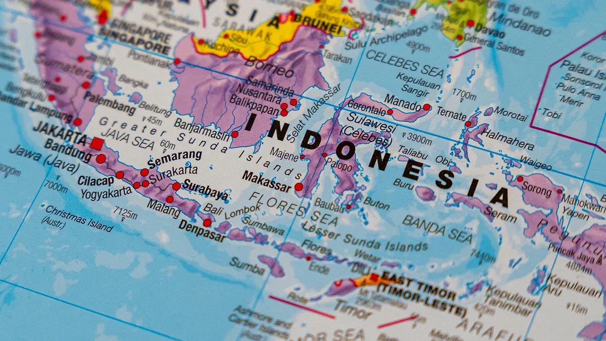 Close-up of a world map focusing on Indonesia, showing major islands and surrounding seas in bright colors.
