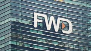 Glass-fronted office building displaying a large white FWD logo with an orange play button on the facade.