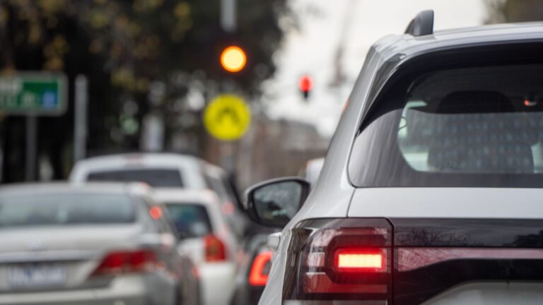 Traffic jam with cars and traffic lights in an urban setting.
