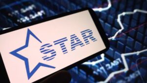 Tablet screen displaying the GSTAR logo with a blue star, held against a background of stock market charts.