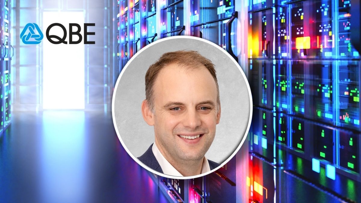 Portrait of a smiling man in a circular frame over a data center background with server racks; QBE logo visible on left.