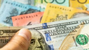 Close-up of a hand holding a stack of U.S. $100 bills with colorful notes in the background.] ORMA error