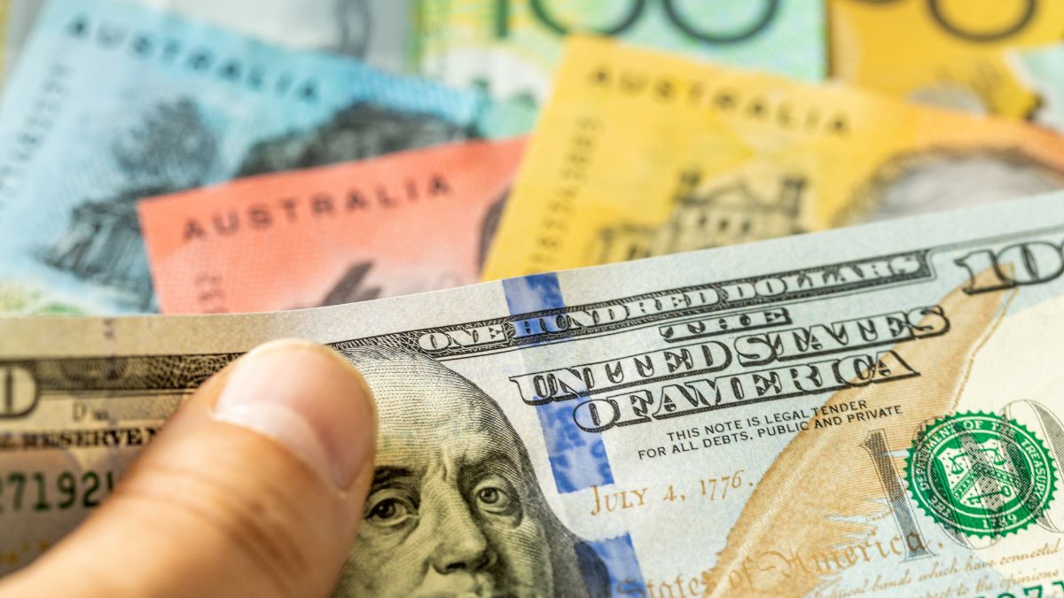 Close-up of a hand holding a stack of U.S. $100 bills with colorful notes in the background.] ORMA error