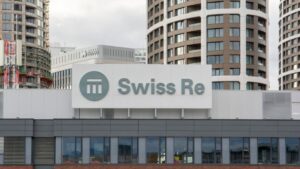 Swiss Re Corporate Solutions logo on a modern building in a cityscape.