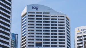 City skyline with modern glass office towers; prominent 'iaq' logo on the central building and Rabobank signage on the right.