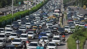 Traffic jam in India with cars and motorcycles on a busy road.