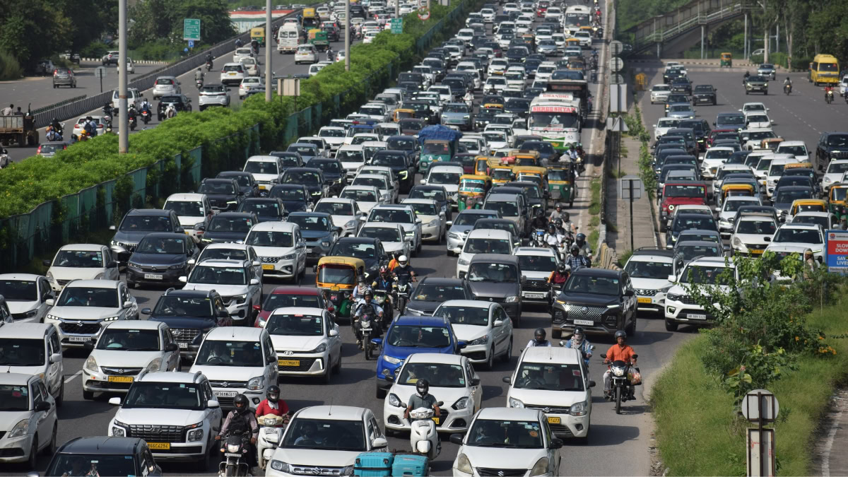 Traffic jam in India with cars and motorcycles on a busy road.