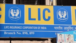 LIC signboard in India with branch numbers and logo, related to LIC's stake sale.
