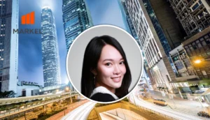 Smiling woman portrait in a circular frame centered over a city skyline with the MARKEL logo in the upper left, a professional header image.