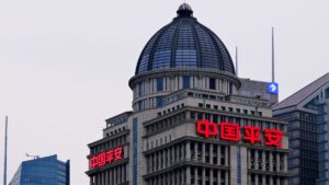 Tall office building with a glass-domed roof and red neon Chinese signage 中国平安 on the facade