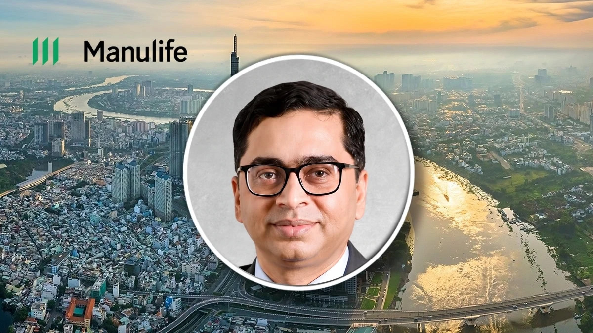 Manulife logo with a professional man in front of a cityscape at sunset.