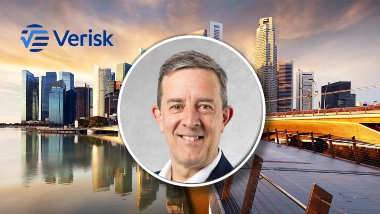 Business professional in front of Sydney skyline with Verisk logo.