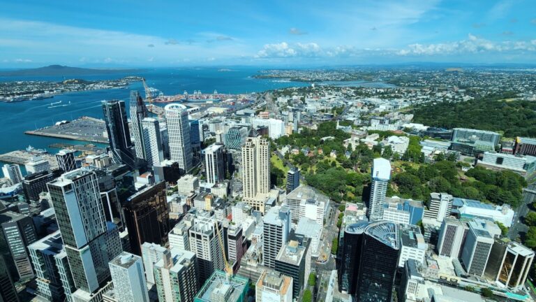 Aerial view of Auckland city skyline, New Zealand, with skyscrapers and harbour.