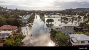 Flooded residential area in Australia after heavy rain, with submerged streets and houses.