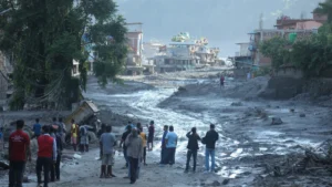 APAC avoids major insured-loss event despite elevated catastrophe activity: Gallagher Re People gather to survey mud and debris covering a residential street.