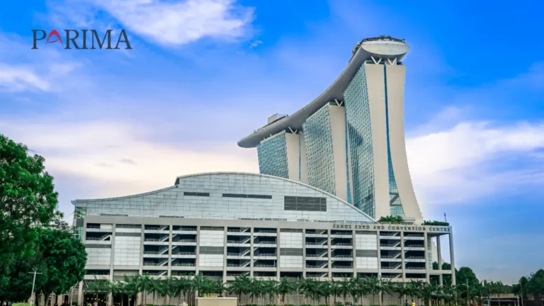Marina Bay Sands hotel and Sands Expo and Convention Centre under a blue sky, with the PARIMA logo.