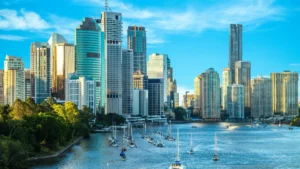 Castle Insurance moves to Canopius capacity after first year with QBE High-rise city skyline overlooking a marina and waterfront under a bright blue sky.