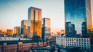 Chariot Re takes on first Japanese liabilities in US$1.6bn MetLife retrocession Modern glass office towers rise behind Tokyo Station in warm evening light.