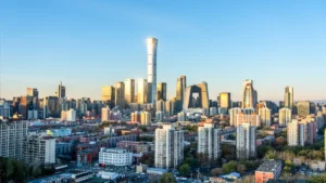 China issues new product development rules for P&C insurers Beijing skyline with the CCTV headquarters and dense residential buildings in the foreground.