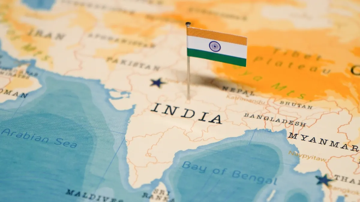 An Indian flag marks India on a map of South Asia.