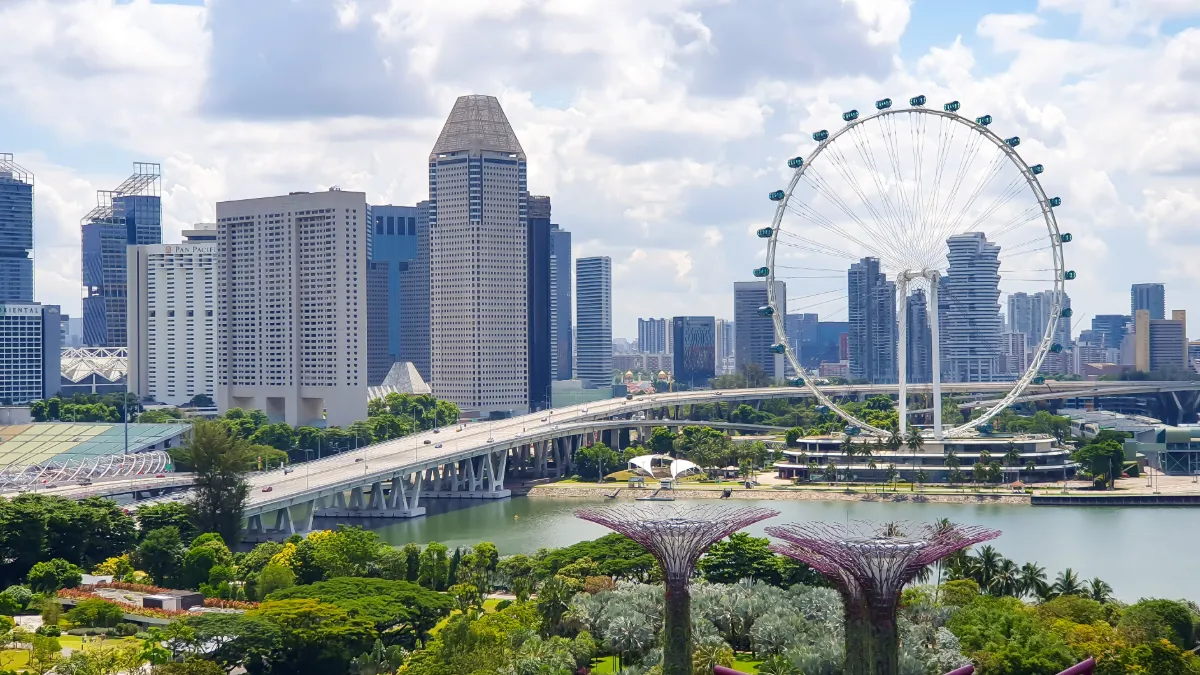 Singapore’s Marina Bay skyline with the Singapore Flyer, waterfront bridge and Gardens by the Bay greenery.