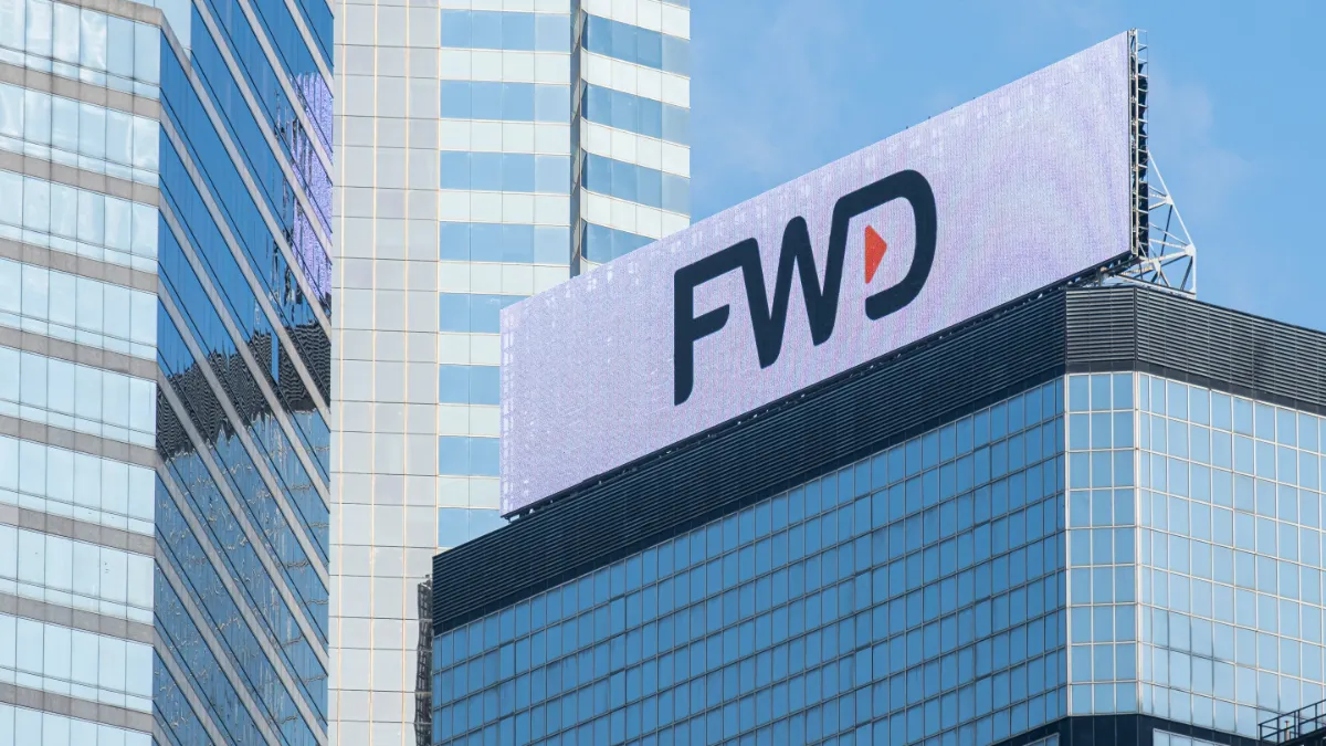 FWD logo displayed atop a modern glass office building.