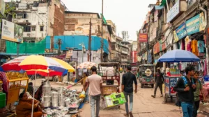 Generali Central, UNDP launch MSME insurance challenge in India Busy Indian market street with pedestrians, vendors, umbrellas, shops and auto-rickshaws.