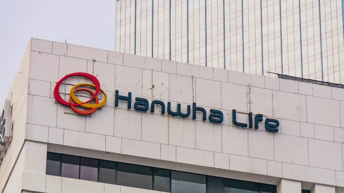Hanwha Life logo on the exterior of a modern office building.