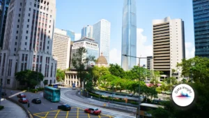 Hong Kong GI direct premiums edge up 1.5% in Q2 as underwriting profit rises to HK$2.43bn Hong Kong cityscape with high-rise buildings, roads, buses and a domed landmark.