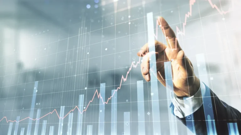 Hand touching a rising financial chart overlaid on bar graphs.